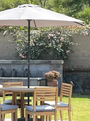 a table and two chairs with an umbrella at Casa de Campo en Cieneguilla in Cieneguilla