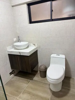 a bathroom with a white toilet and a sink at Minidepartamento en Miraflores in Lima