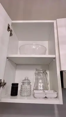 a white cabinet with a glass pitcher and other items on it at 1 dormitorio moderno con balcon a 5 min de parque Kennedy-Miraflores in Lima