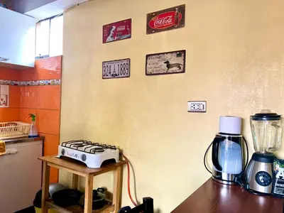 a kitchen with a stove and a blender on a table at Departamento a 5 cuadras de la Plaza de Armas Cusco in Cusco