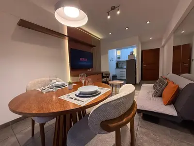 a dining room and living room with a table and chairs at Boulevard Apartments by Vibrant in Lima