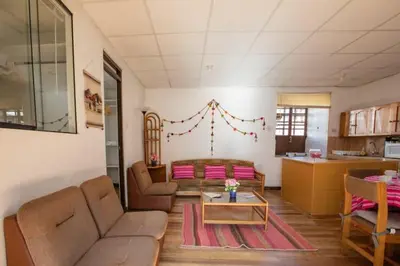 a living room with a couch and a table at Departamento a 2 cuadras de la Plaza de Armas in Cusco