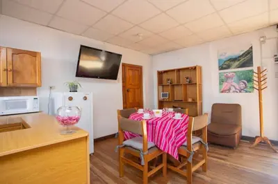 a kitchen with a table with a pink table cloth on it at Departamento a 2 cuadras de la Plaza de Armas in Cusco