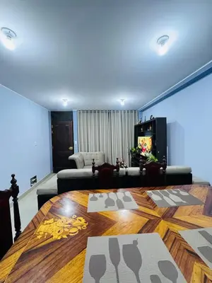 a living room with a table and a couch at Departamento 2 Dormitorios, zona tranquila, Ideal 4 Personas El Tambo in Huancayo