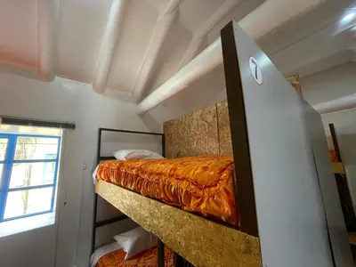 a bedroom with a bunk bed and a window at Hostel - Cusco Dorms in Cusco