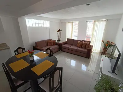 a living room with a table and a couch at Apart El Alba III en Centro Historico de Cusco in Cusco