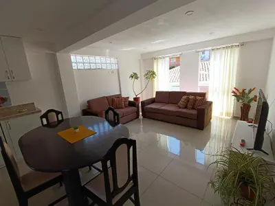 a living room with a table and a couch at Apart El Alba III en Centro Historico de Cusco in Cusco