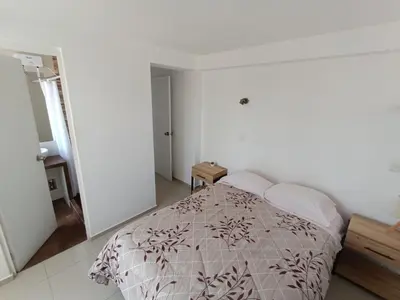 a bedroom with a bed in a white room at Apart El Alba III en Centro Historico de Cusco in Cusco