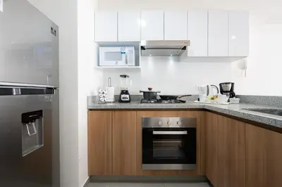 a kitchen with a stove top oven and a sink at Aquilarias Apartments by Vibrant in Lima