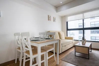 a living room with a table and a couch at Aquilarias Apartments by Vibrant in Lima