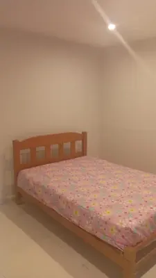 a bedroom with a wooden bed with flowers on it at DEPARTAMENTO AMOBLADO POR TEMPORADA DE PLAYA En PUNTA HERMOSA in Punta Hermosa