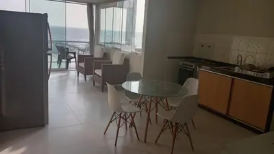 a kitchen with a table and chairs and the ocean at DEPARTAMENTO AMOBLADO POR TEMPORADA DE PLAYA En PUNTA HERMOSA in Punta Hermosa