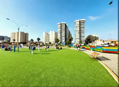 a park with people playing in the grass in a city at Ocean Sunset vista al mar, piscina y balcón in Lima