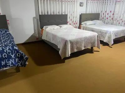 two beds sitting in a room with at VICTORIA HOUSE - Huancayo - Hualhuas in Hualhuas