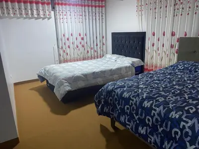 a bedroom with two beds and a window at VICTORIA HOUSE - Huancayo - Hualhuas in Hualhuas