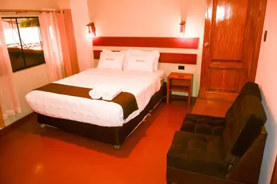 a hotel room with a bed and a chair at Hotel Boutique MIRANDO AL SOL in Ollantaytambo