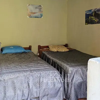 two beds sitting next to each other in a room at Casitas Choquequirao Chikiska in Abancay