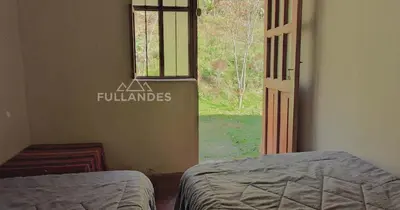 a bedroom with a window and two beds in a room at Casitas Choquequirao Chikiska in Abancay