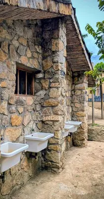 a stone building with sinks on the side of it at Casitas Choquequirao Chikiska in Abancay
