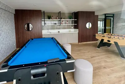 a living room with a pool table and chessboard at Habitación privada en departamento compartido in Lima