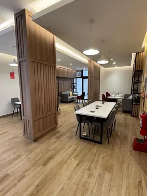 an office with a table and chairs in a room at Cuarto privado en departamento compartido in Lima