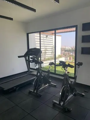 a gym with two exercise bikes and a treadmill at New and modern flat in Barranco & Miraflores in Lima