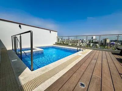 a swimming pool on the roof of a building at New and modern flat in Barranco & Miraflores in Lima