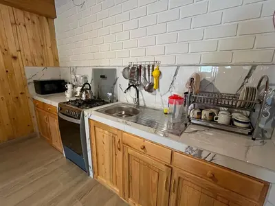 a kitchen with a sink and a stove at Hassinger Haus in Oxapampa