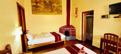 a bedroom with a bed and a fireplace at PLAZA cusco Amankay in Cusco