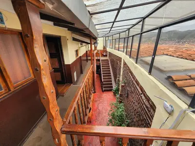 a balcony of a building with stairs and a view at PLAZA cusco Amankay in Cusco