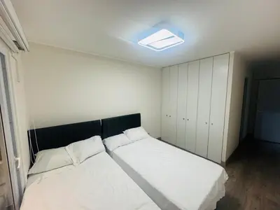 a bedroom with two beds and a ceiling with a light at Beautiful penthouse in the heart of Miraflores in Lima