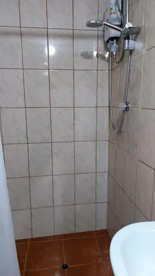 a shower in a bathroom with a tile wall at Altos Del Valle in Cusco