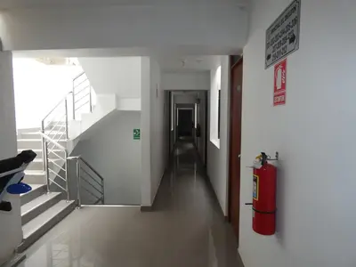 a hallway with a fire hydrant in a building at Hotel Lima Norte in Carabayllo
