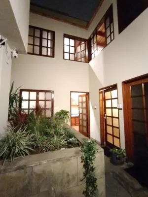 a large house with doors and plants in it at Casa Cota in Lima