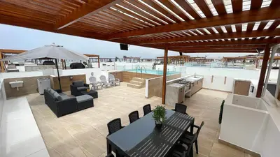 a patio with a table and chairs and a pool at Casa Playa Azul Verano 2026 Asia in Cerro Azul