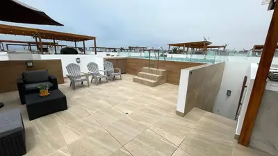 a rooftop patio with chairs and a bar on a boat at Casa Playa Azul Verano 2026 Asia in Cerro Azul