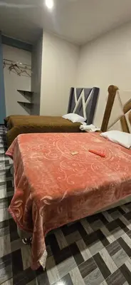 a room with two beds with a red blanket at Hotel gym club33 in Huancayo