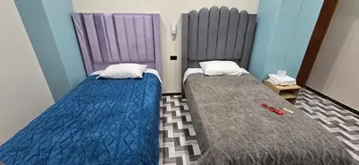 two beds sitting next to each other in a room at Hotel gym club33 in Huancayo
