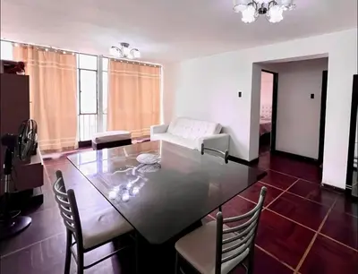 a living room with a table and a couch at Smart apart in Lima