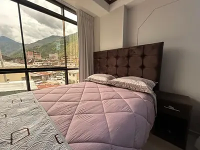 a bedroom with a large bed with a large window at Hotel Wasichay - Santa teresa in Santa Teresa