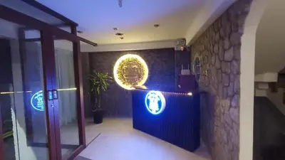 a lobby with a blue wall with a sign on it at Hotel Wasichay - Santa teresa in Santa Teresa