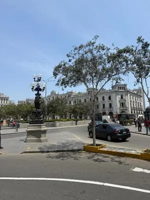 a street with a car parked in front of a building at Apartment in Lima's historic center in Lima