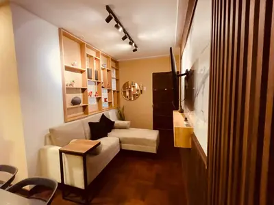 a living room with a couch and a table at Estancia Ideal in Lima
