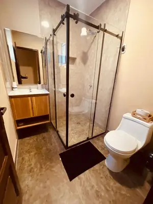 a bathroom with a shower with a toilet and a sink at Estancia Ideal in Lima