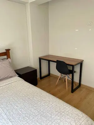 a bedroom with a desk and a bed and a desk and chair at Room with 2 beds - Shared Apartment in Lima