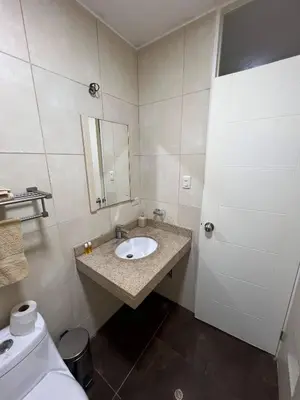 a bathroom with a sink and a toilet and a mirror at Room with 2 beds - Shared Apartment in Lima