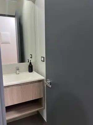 a bathroom with a sink and a mirror at Modern Apartment for 9 San Isidro in Lima