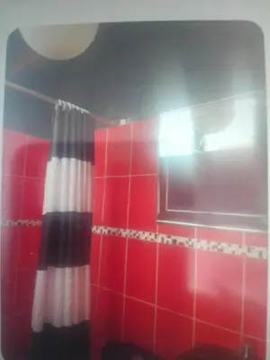 a red and white shower curtain in a bathroom at Miraflores Effyciency 5to piso in Lima