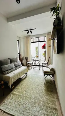 a living room with a couch and a table at Mini in Punta Hermosa