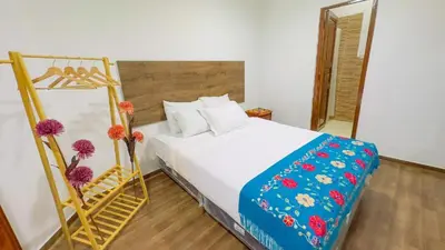 a bedroom with a bed with a ladder and flowers at Casona MICA'S HOUSE in Cusco